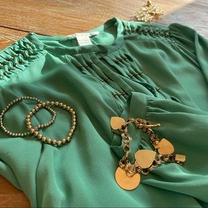 Elegant DVF long sleeved jade blouse with gold details. Size 4.